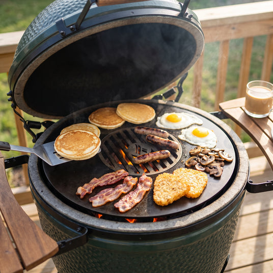 Pancakes, eggs, bacon, hash browns and mushrooms on the Arteflame griddle ring with sausages on the center grate of a green kamado grill