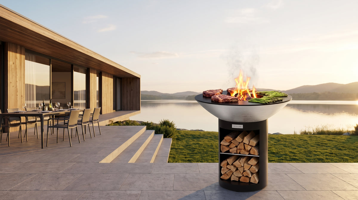 Arteflame 40-inch Platinum Series stainless steel grill with storage base on the terrace of a modern lakeside home at golden hour