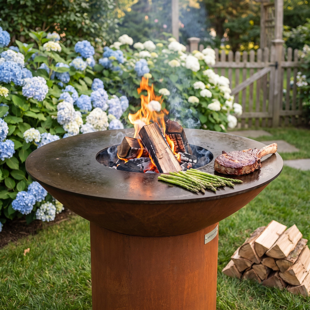 Arteflame wood-fired flat-top grill with round Corten steel base: Advantages of Burning Wood in a Charcoal Grill