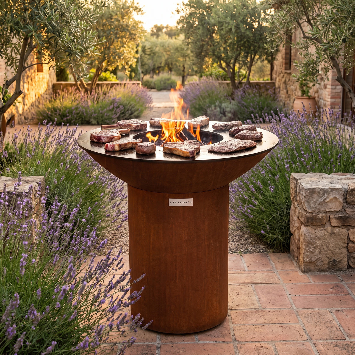 Arteflame wood-fired flat-top grill with round Corten steel base: Best Steak Cuts for Grilling