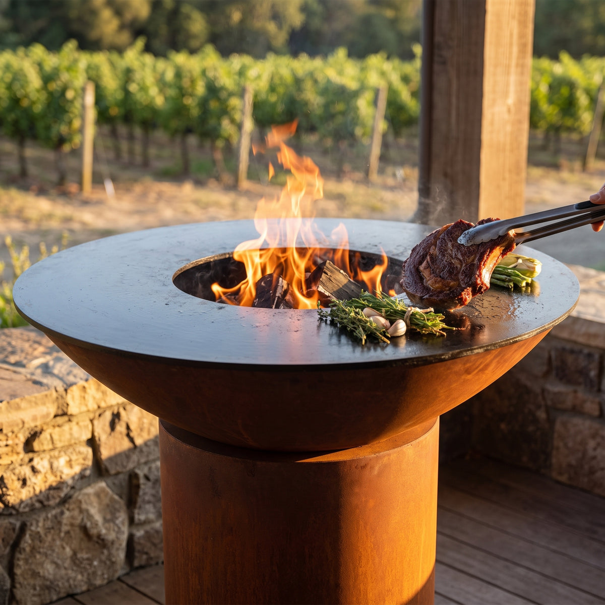Arteflame wood-fired flat-top grill with round Corten steel base: Grill The Perfect Steak