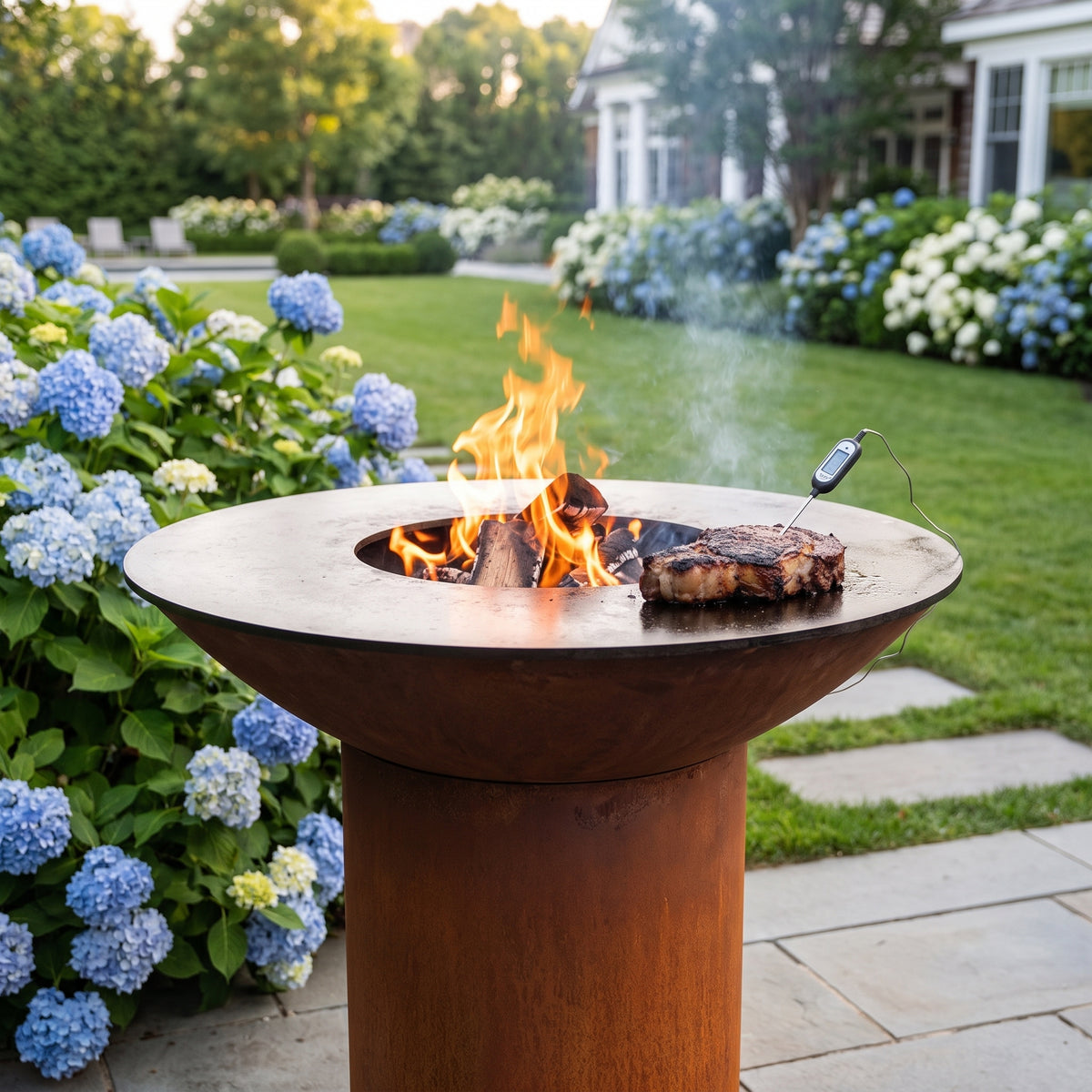 Arteflame wood-fired flat-top grill with round Corten steel base: Reverse Sear Steak