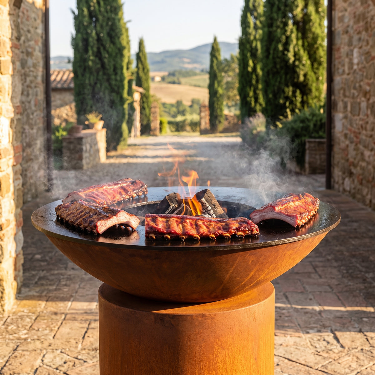 Arteflame wood-fired flat-top grill with round Corten steel base: Smoke Ribs