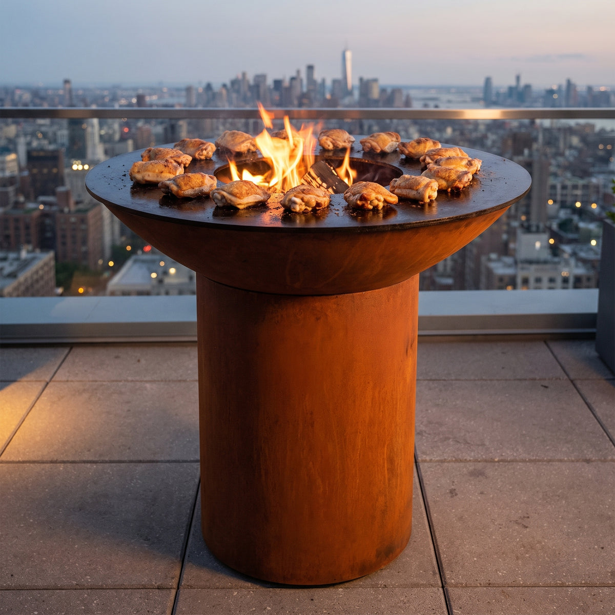 Crispy-skin chicken thighs grilling on an Arteflame wood-fired flat-top grill with a round Corten steel base