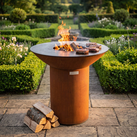 Arteflame wood-fired flat-top grill with round Corten steel base: Wood-Fired vs Gas Grilling