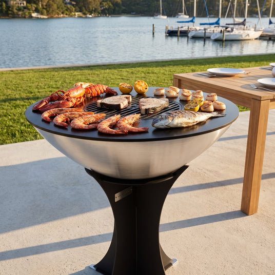 Lobster tails, prawns, scallops and sea bream on the Arteflame 40-inch Platinum Series stainless steel grill by the water