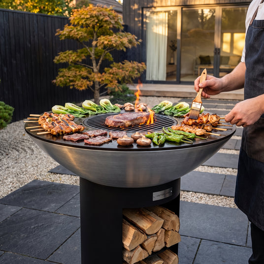Yakitori and wagyu on the Arteflame 40-inch Platinum Series stainless steel grill with storage base in a Japanese-inspired garden
