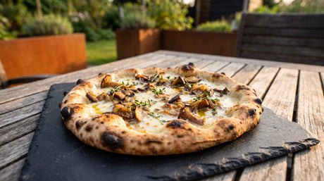 White pizza with wild mushrooms, fontina and truffle oil on a slate board - Arteflame Pizza Oven Kit